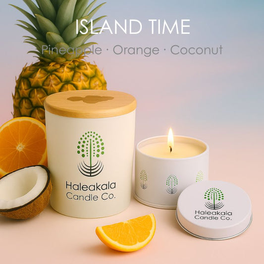 Haleakala Candle Co. candle with pineapple, orange, and coconut on a gradient background